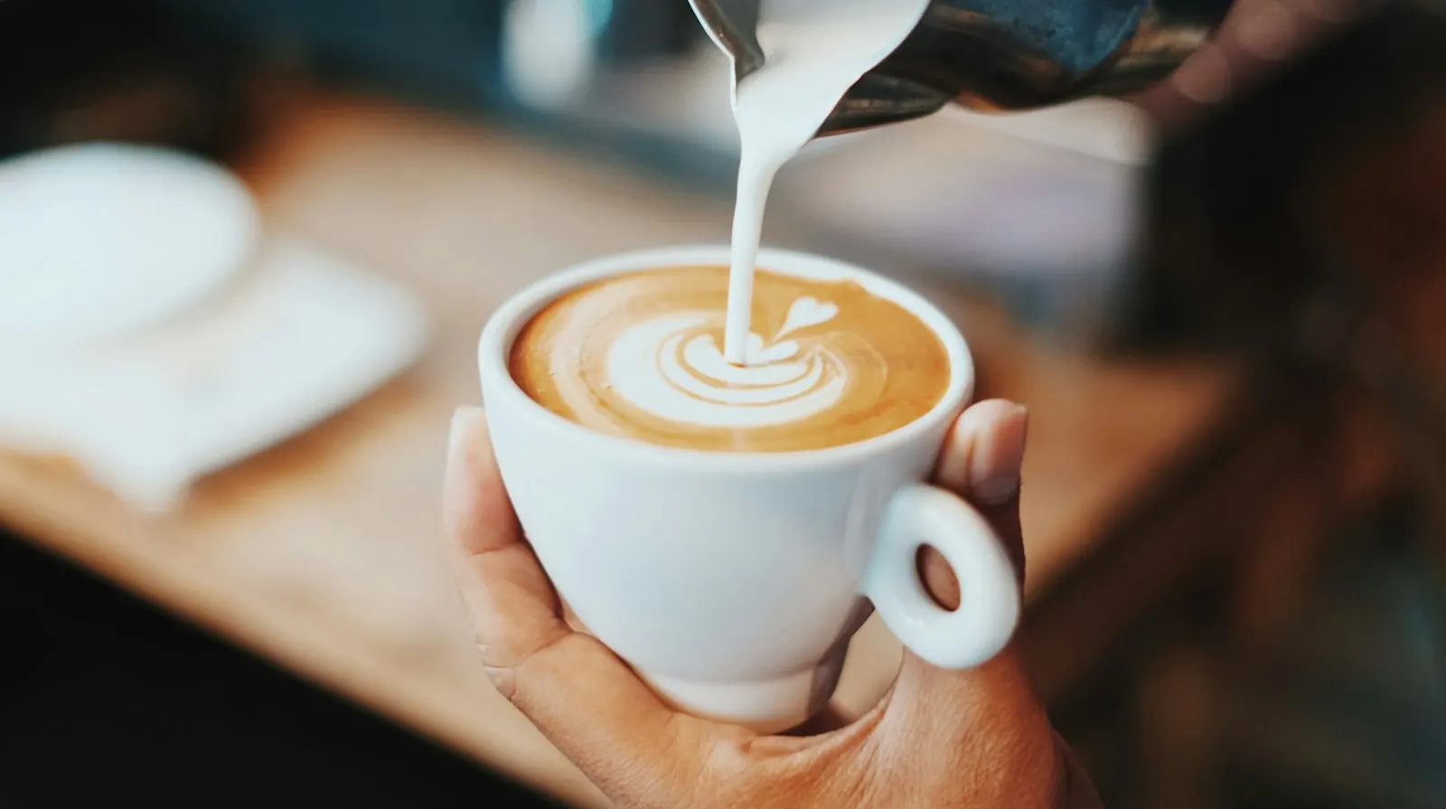 Latte art photographed from directly above on a warm wood table