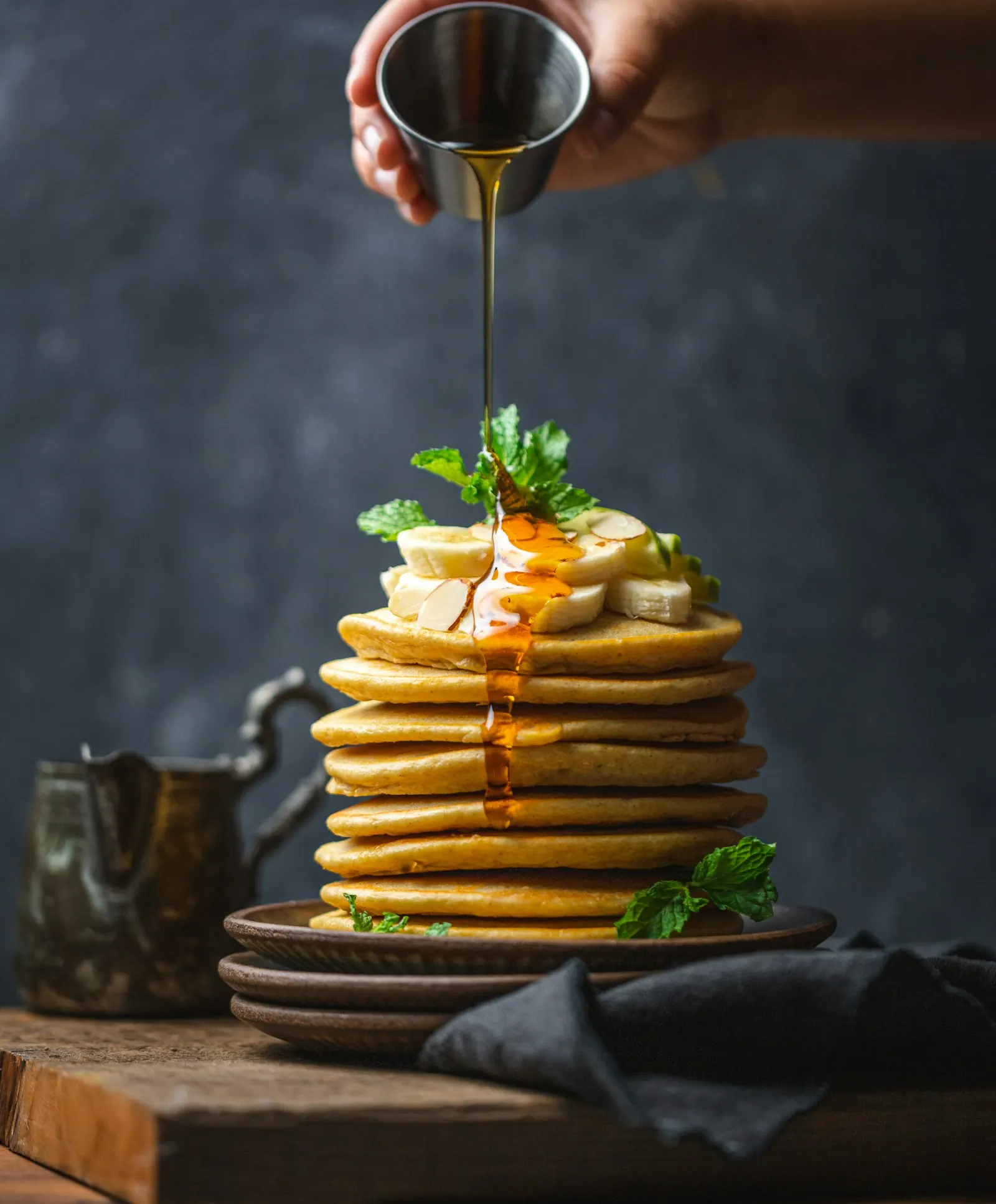 Hotcakes stacked with berries and dripping sauce