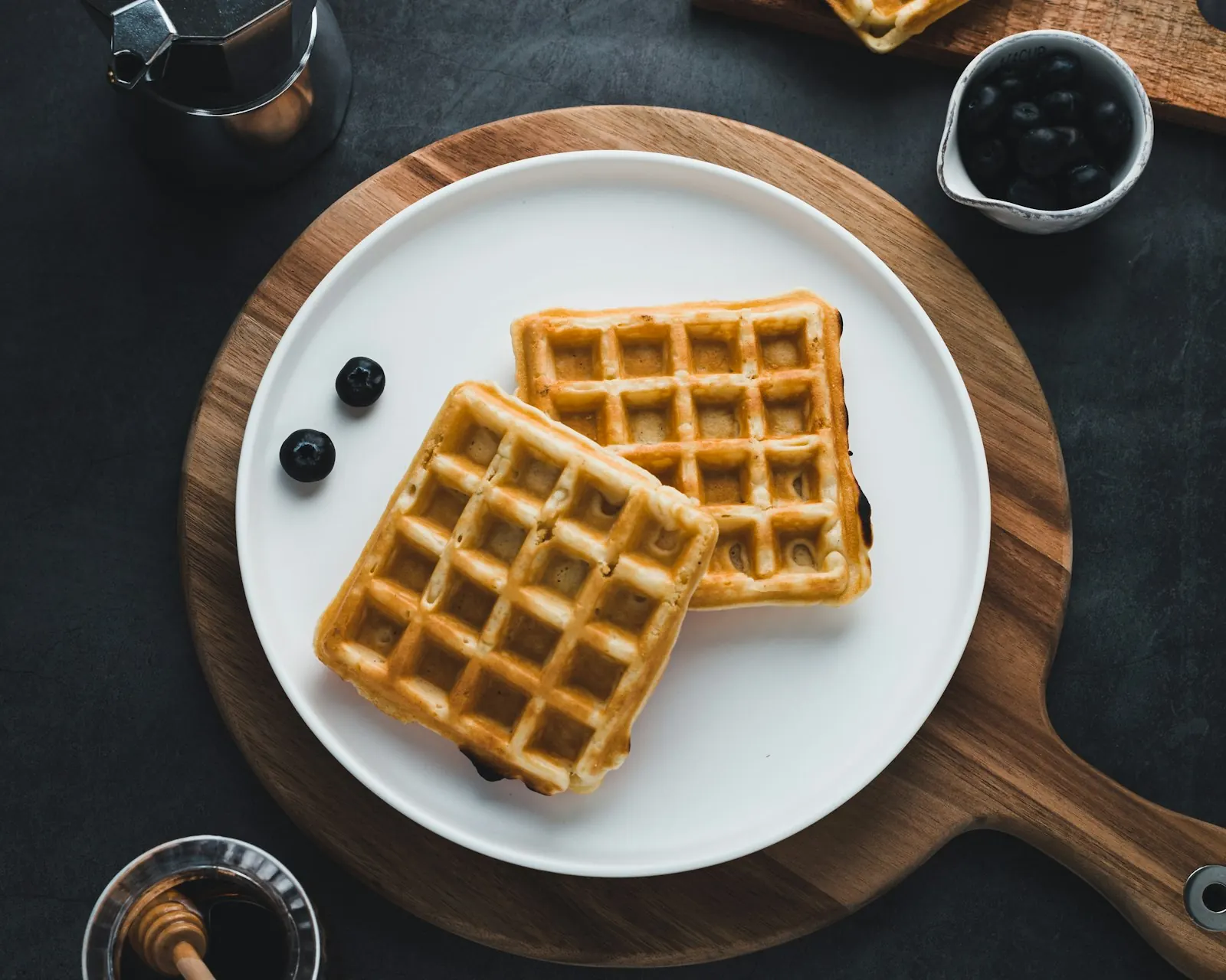 Waffles with maple syrup and blueberries, overhead